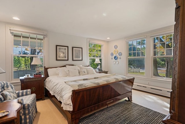 carpeted bedroom with a baseboard radiator