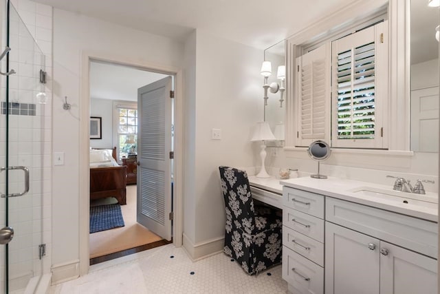 bathroom featuring vanity, a shower with shower door, and tile patterned floors