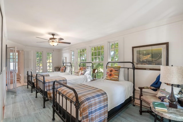 bedroom featuring ornamental molding, hardwood / wood-style floors, and ceiling fan