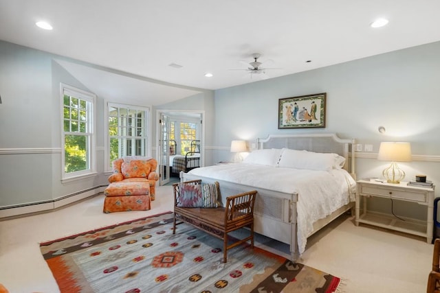 carpeted bedroom with a baseboard radiator and ceiling fan