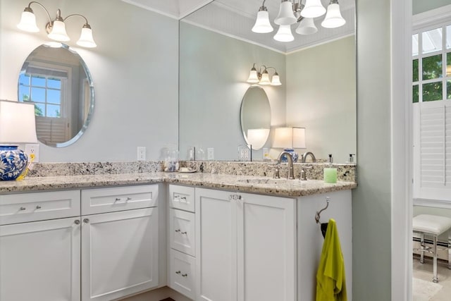 bathroom with crown molding, vanity, and baseboard heating