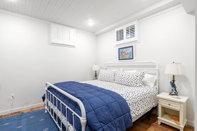 bedroom with dark hardwood / wood-style flooring