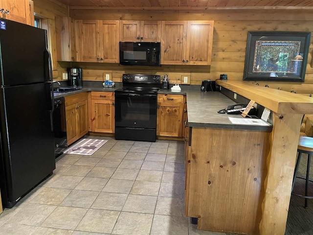 kitchen with wooden ceiling, black appliances, light tile patterned flooring, and wood walls