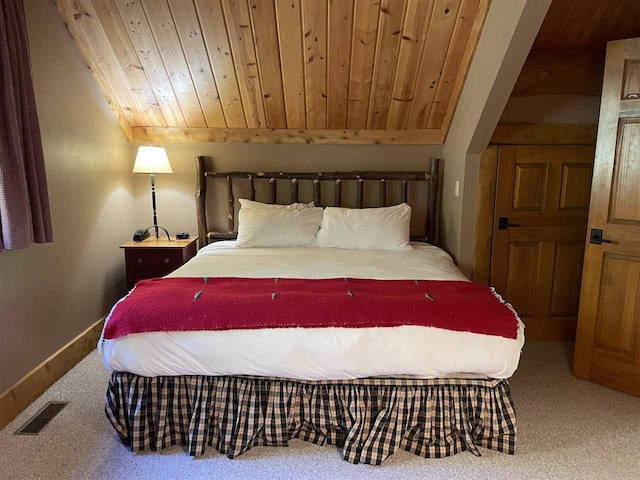 bedroom featuring carpet floors, lofted ceiling, and wood ceiling