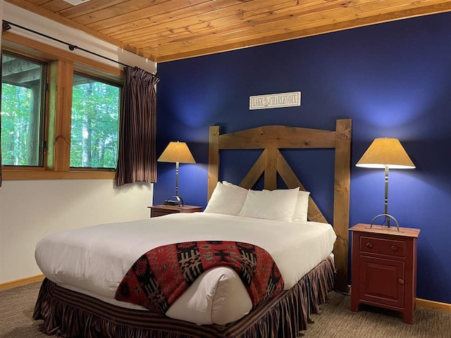 bedroom with wood ceiling and carpet flooring