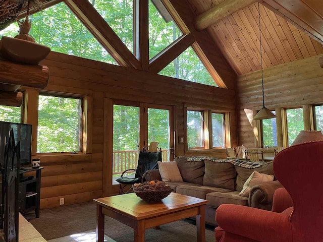 carpeted living room featuring beamed ceiling, rustic walls, and high vaulted ceiling