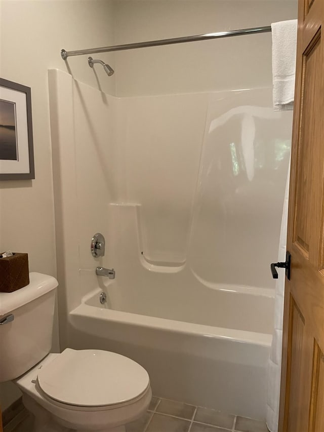 bathroom with tile patterned flooring, toilet, and shower / bathtub combination