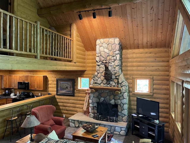 living room featuring high vaulted ceiling, a stone fireplace, wooden ceiling, beam ceiling, and rustic walls