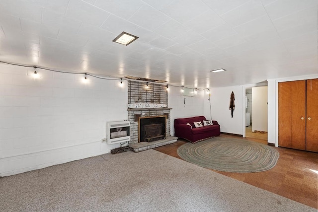 living room with a brick fireplace and heating unit