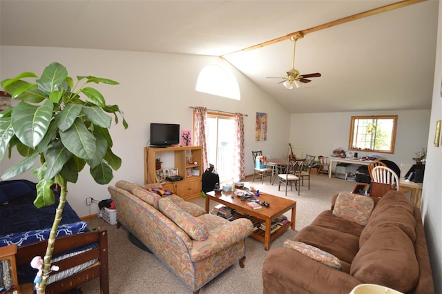 living room with lofted ceiling, ceiling fan, and carpet flooring