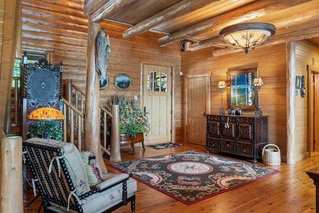 foyer entrance featuring hardwood / wood-style floors, wooden ceiling, and beamed ceiling