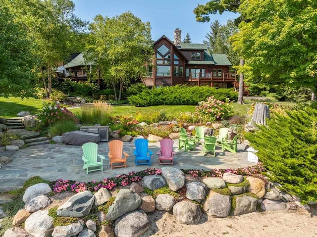 view of yard with a patio and a wooden deck