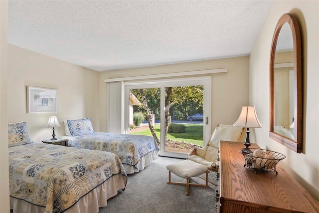 bedroom featuring access to outside, a textured ceiling, and carpet flooring