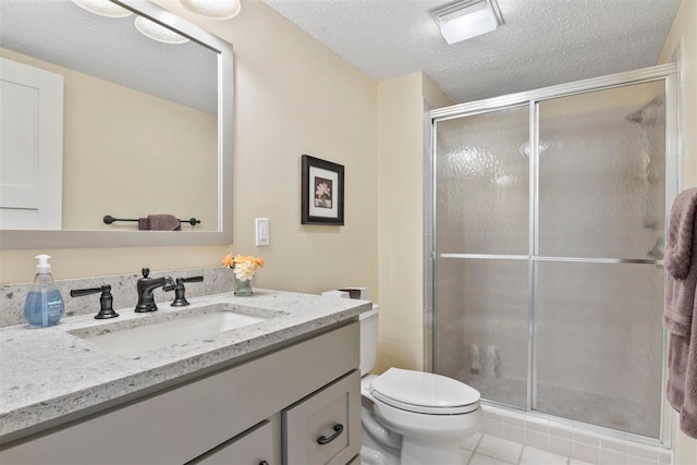 bathroom featuring vanity, an enclosed shower, a textured ceiling, tile patterned floors, and toilet