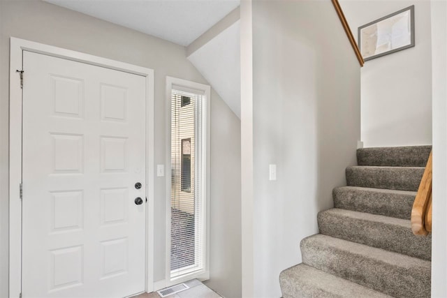 foyer featuring vaulted ceiling