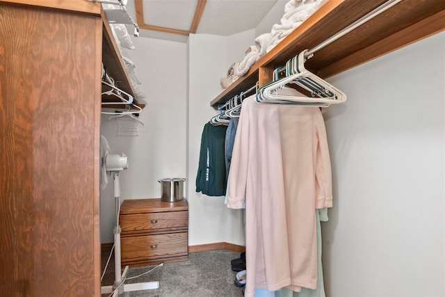 spacious closet featuring dark carpet