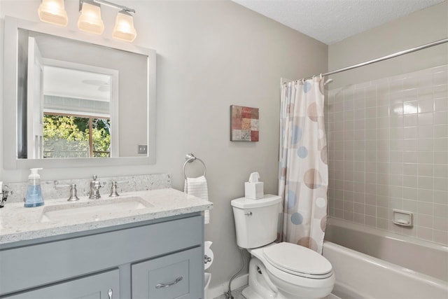 full bathroom featuring shower / bath combo, a textured ceiling, vanity, and toilet