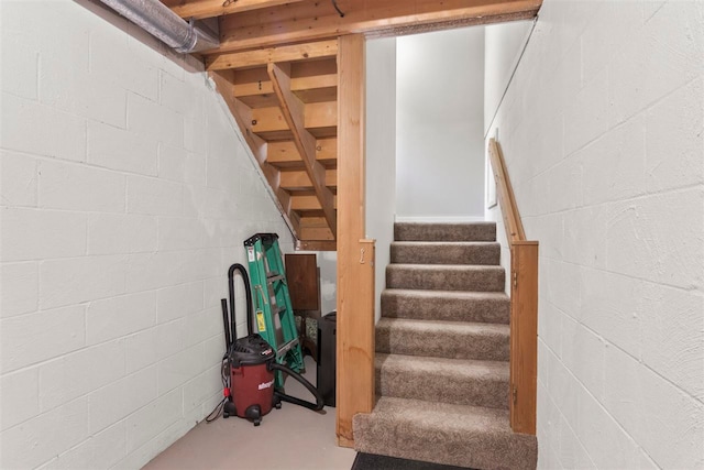 staircase with concrete flooring