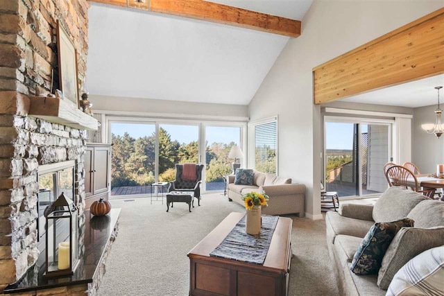 carpeted living room with high vaulted ceiling, beam ceiling, a notable chandelier, and a fireplace