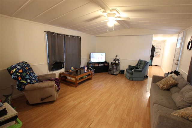 living room with vaulted ceiling with beams, light hardwood / wood-style floors, and ceiling fan