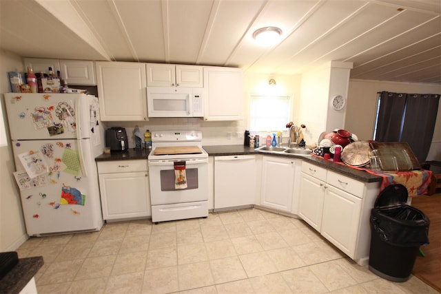 kitchen featuring decorative backsplash, white appliances, sink, and white cabinets