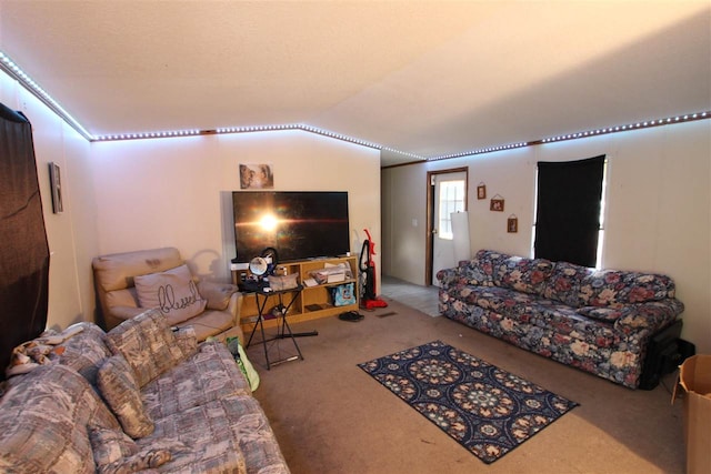 carpeted living room featuring lofted ceiling