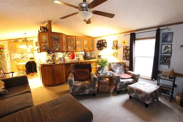 carpeted living room with a textured ceiling, ceiling fan with notable chandelier, lofted ceiling, and ornamental molding