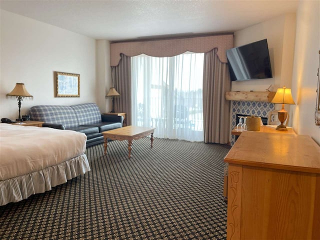 bedroom featuring a textured ceiling and dark colored carpet