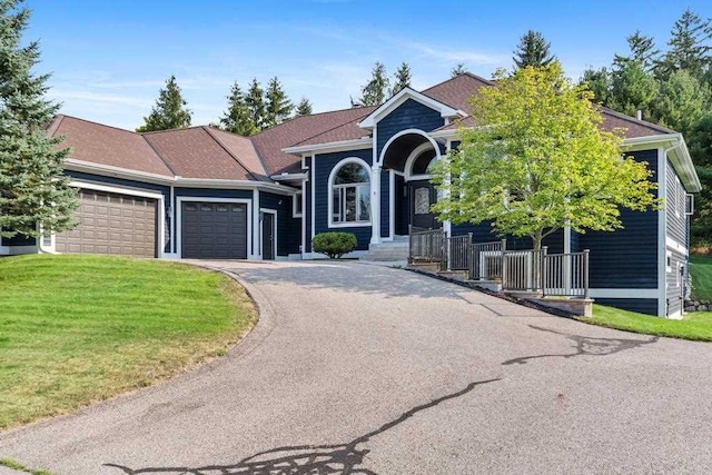 view of front of home with a garage and a front lawn