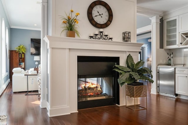 290 Mitchell Hills Dr, Petoskey, MI 49770 - detailed view of a multi sided fireplace, refrigerator, wood finished floors, crown molding, and recessed lighting