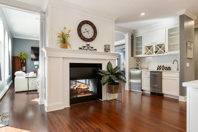 290 Mitchell Hills Dr, Petoskey, MI 49770 - indoor wet bar featuring fridge, ornamental molding, a multi sided fireplace, dark wood-style floors, and stainless steel dishwasher