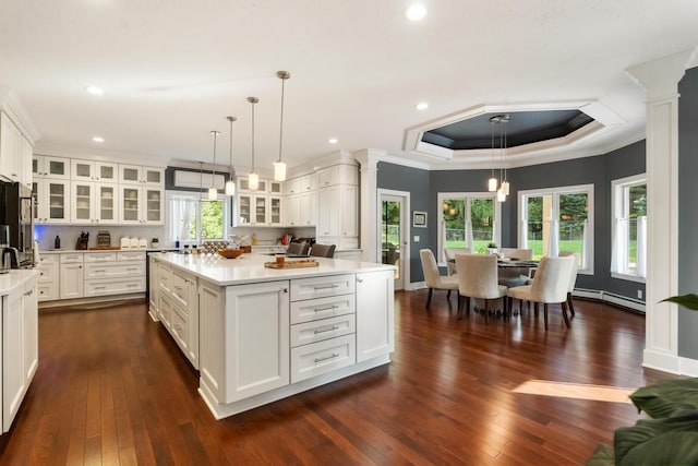 290 Mitchell Hills Dr, Petoskey, MI 49770 - kitchen featuring ornate columns, a baseboard heating unit, light countertops, dark wood finished floors, and crown molding