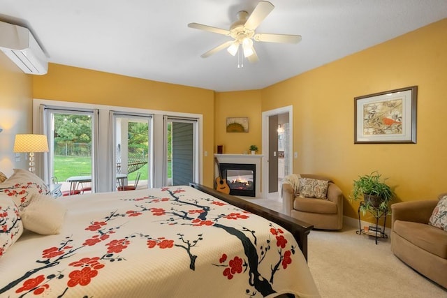 290 Mitchell Hills Dr, Petoskey, MI 49770 - bedroom with access to outside, a wall mounted AC, carpet floors, a multi sided fireplace, and ceiling fan
