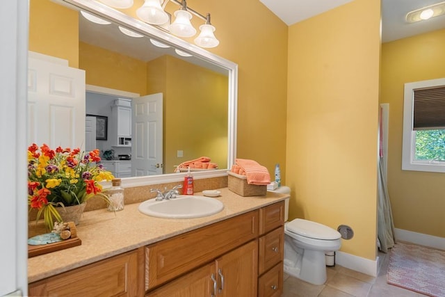 290 Mitchell Hills Dr, Petoskey, MI 49770 - full bathroom with toilet, vanity, tile patterned flooring, and baseboards
