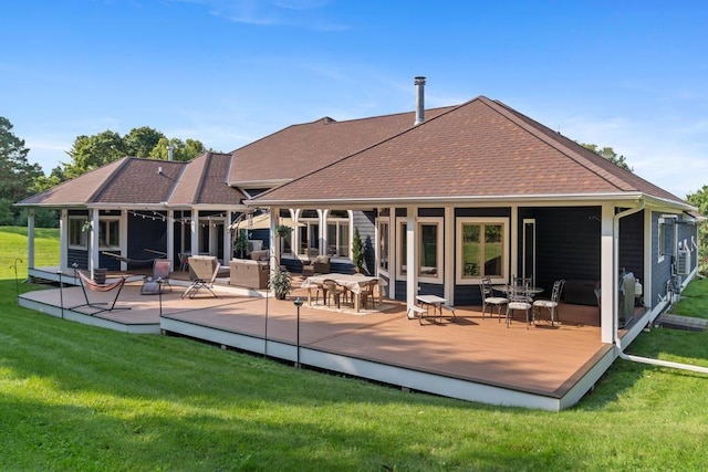 290 Mitchell Hills Dr, Petoskey, MI 49770 - back of property with roof with shingles, a wooden deck, and a lawn