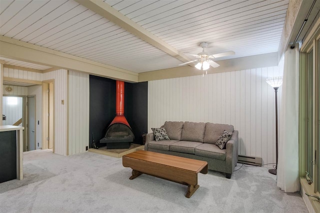 2500 Josef Strasse Unit 410/411, Bellaire, MI 49615 - living room with a wood stove, carpet, baseboard heating, and beamed ceiling