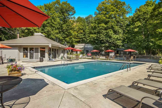 2500 Josef Strasse Unit 410/411, Bellaire, MI 49615 - community pool with an outbuilding, a patio area, and fence
