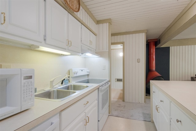 kitchen with white cabinets, wood walls, sink, white appliances, and wooden ceiling