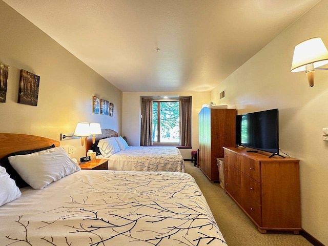 bedroom featuring light colored carpet