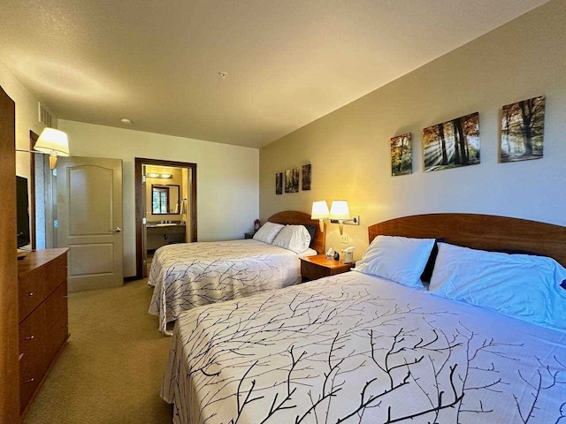 carpeted bedroom with lofted ceiling