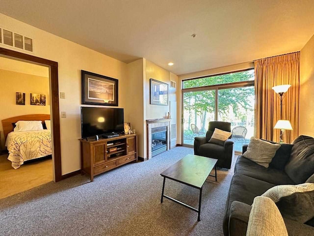 living room featuring carpet floors and a fireplace