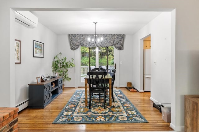 dining room featuring a notable chandelier, hardwood / wood-style floors, a wall mounted AC, and baseboard heating