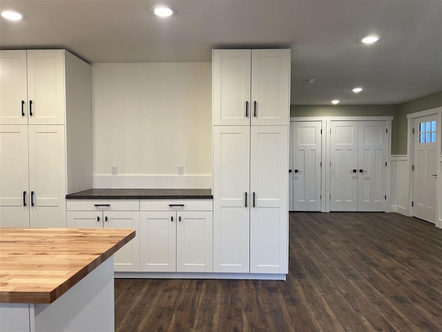 kitchen featuring white cabinets, dark hardwood / wood-style flooring, and wooden counters