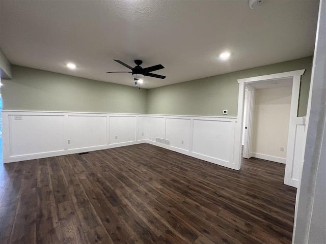 spare room with ceiling fan and dark hardwood / wood-style flooring