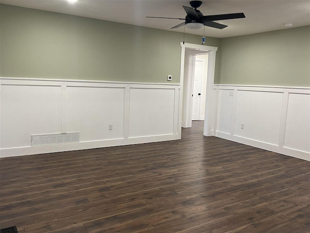 spare room featuring ceiling fan and dark wood-type flooring