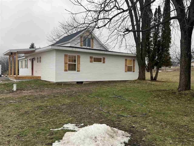 view of property exterior with a yard and a deck