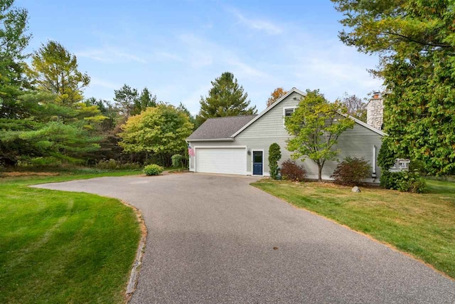 view of front of property with a front yard and a garage