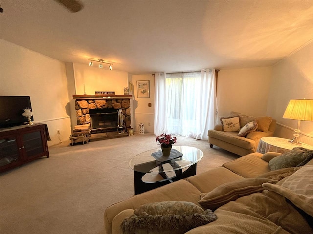 living room featuring a stone fireplace and light colored carpet