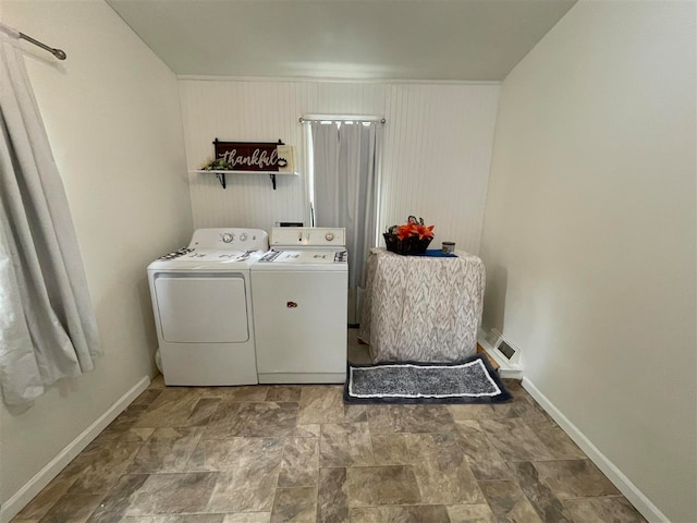 laundry area featuring washing machine and clothes dryer