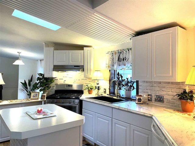 kitchen with white cabinetry, sink, stainless steel appliances, and decorative light fixtures